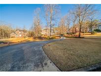 Elegant brick homes line a driveway amid a picturesque landscape with mature trees at 2400 Stedman Sw Ln, Conyers, GA 30094
