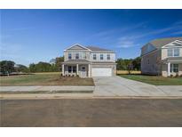 Two-story brick home with a gray front door and attached garage at 249 Chiswick Loop, Stockbridge, GA 30281