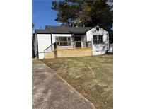 Charming white house with a new deck and landscaped yard at 2736 Joyce Ave, Decatur, GA 30032