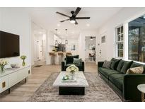 Bright living room features modern decor, stylish furnishings, and seamless flow to the kitchen at 2736 Joyce Ave, Decatur, GA 30032