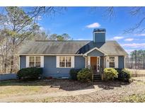 Ranch style home with blue siding, white trim, and a spacious yard at 446 Mcgukin Rd, Bremen, GA 30110