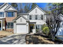 Charming two-story home features a one-car garage and welcoming front entrance at 221 Kenninghall Se Ln, Smyrna, GA 30082