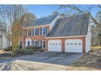 Brick two-story house with a two-car garage and landscaped yard at 3422 Sweetbriar Ln, Powder Springs, GA 30127