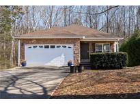 Ranch style home with stone accents and a two-car garage at 4458 English Loop, Lithonia, GA 30038