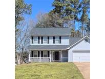 Charming two-story home with a covered front porch, black shutters and an attached two-car garage at 3810 Rex Mill Sq, Rex, GA 30273