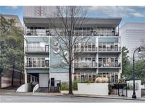 Modern condominium building showcasing large windows and balcony spaces in a thriving urban location at 33 Ponce De Leon Ne Ave # 203, Atlanta, GA 30308