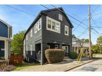 Dark gray exterior of charming two-story home with a well-manicured front yard at 66 Howell Ne St, Atlanta, GA 30312