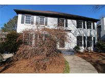 Two-story white brick home with black shutters and landscaping at 3035 Saint Andrews Dr, Duluth, GA 30096