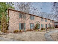 Charming brick townhouse featuring lush landscaping and a well-maintained lawn at 3103 Colonial Way # A, Chamblee, GA 30341