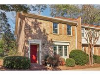 Charming two-story brick home with a vibrant red front door and manicured landscaping at 3420 Ashwood Ln # 3420, Atlanta, GA 30341