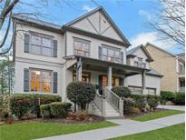 Two-story house with gray siding, shutters, and a covered porch at 627 Village Manor Pl, Suwanee, GA 30024