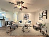 Inviting living room featuring a ceiling fan, neutral paint, stylish furnishings, and a decorative rug at 2249 Runnymead Se Rdg, Marietta, GA 30067