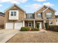 Two story brick home with a two car garage and manicured lawn at 2756 Palmview Sw Ct, Atlanta, GA 30331