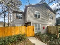 Gray two-story house with a wooden fence and gate at 1089 Brittwood Pl, Norcross, GA 30093
