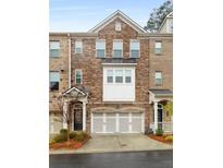 Charming townhome featuring a stone facade, inviting entryway, and a convenient two-car garage at 1391 Harris Way, Brookhaven, GA 30319