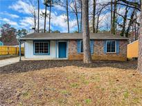 Charming single-story home with brick and siding, front yard landscaping, and inviting blue accents at 1173 Brockdell Ct, Norcross, GA 30093