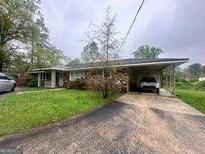 Charming single-story home with a covered carport and a well-maintained front yard at 3710 Lynn Dr # A & B, Powder Springs, GA 30127