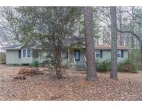 Charming ranch-style home featuring a well-maintained front yard and a cozy entrance at 180 Sears Cir, Covington, GA 30016