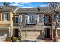 Charming brick townhome with a two-car garage, Juliette balcony, and well-maintained landscaping at 6369 Queens Court Trce, Mableton, GA 30126