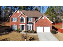 Brick house with 2-car garage, and landscaping at 618 Rebecca Ives Nw Dr, Lilburn, GA 30047