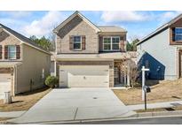 Two-story brick home with attached garage and driveway at 8785 Seneca Rd, Palmetto, GA 30268