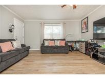Living room with two sofas, light flooring, and a TV at 365 Winding River Dr # E, Atlanta, GA 30350