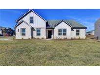Two-story house with white brick and gray roof, nicely landscaped lawn at 8 Longhorn Way, Auburn, GA 30011