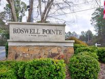 Roswell Pointe community sign with stone base surrounded by green shrubbery at 3412 Lake Pointe Cir, Roswell, GA 30075
