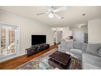 Spacious living room with hardwood floors, large sectional sofa, and a ceiling fan at 4333 Dunwoody Park # 2207, Atlanta, GA 30338