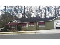 Ranch-style home with maroon awnings and a detached garage at 1004 Marietta Rd, Canton, GA 30114