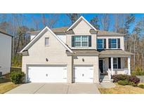 Charming two-story brick home featuring a two-car garage and inviting front porch, perfect for suburban living at 2536 Dayview Ln, Atlanta, GA 30331