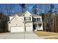 Charming two-story home with a painted brick exterior, black shutters and a two car garage at 2536 Dayview Ln, Atlanta, GA 30331