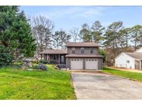 Charming two-story home with a well-maintained lawn and a two-car garage at 1444 Harbins Ridge Dr, Norcross, GA 30093