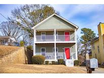 Two-story house with gray siding, white railings, and a red front door at 2650 Batavia St, East Point, GA 30344