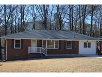 Brick ranch home with a gray roof, white porch railing, and a well-maintained lawn at 2773 Fairlane Dr, Atlanta, GA 30354