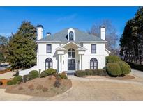 Stunning white home featuring manicured landscaping and architectural details at 4011 Charrwood Trce, Marietta, GA 30062