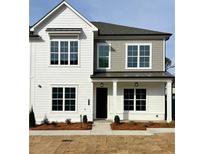 Charming two-story home features a combination of white siding and gray shingles with black window trim at 401 Nettle Ct, Woodstock, GA 30188