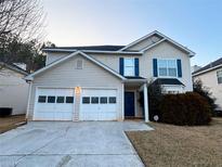 Charming two-story home with a two-car garage and well-maintained landscaping at 4547 Carriage Park Dr, Lithonia, GA 30038