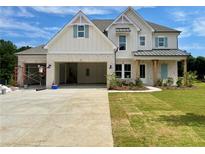 Charming two-story home featuring a three-car garage, white brick, light blue shutters, and manicured lawn at 679 Crest Line Trl, Powder Springs, GA 30127