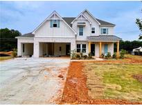 Beautiful new construction featuring light brick, wood columns and a large three car garage at 679 Crest Line Trl, Powder Springs, GA 30127