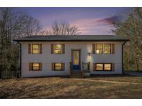 Newly renovated home with white siding, blue door, and landscaping at 942 Azalea Cir, Marietta, GA 30062