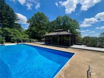 Stunning pool with gazebo and ample lounge area surrounded by lush landscaping at 202 Heights Pl, Canton, GA 30114