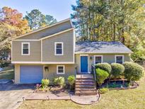 Attractive ranch home with a landscaped yard and attached garage at 3700 Ashley Woods Dr, Powder Springs, GA 30127