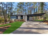 Charming exterior of a two-story home featuring a carport and manicured lawn at 3732 Summitridge Dr, Atlanta, GA 30340