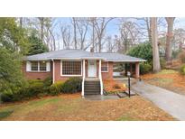 Brick ranch house with attached carport and landscaped yard at 2044 Wilandrew Dr, Decatur, GA 30033