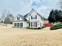 Charming two-story home with classic architecture and well-manicured landscaping at 100 Cottonwood Pl, Stockbridge, GA 30281