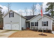 Charming two-story home with a two car garage, flag pole and well maintained lawn at 612 Cole Creek Dr, Dallas, GA 30157