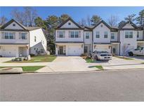 Charming townhomes boast eye-catching shutters and attached garages, offering modern living at 4191 Spring Valley Cir, Tucker, GA 30084