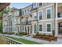 Charming townhome exterior with manicured landscaping, brick accents, and neutral colors at 2531 High Brow St # 41, Duluth, GA 30096