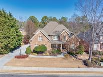 Brick house with landscaped yard and driveway at 3795 Greenside Ct, Dacula, GA 30019